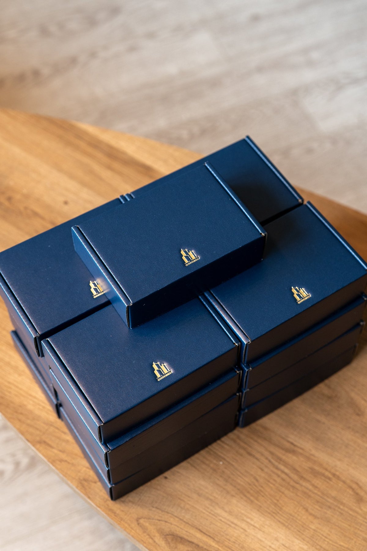 Navy gift boxes with gold foil CODENEXT logo for a corporate employee gift